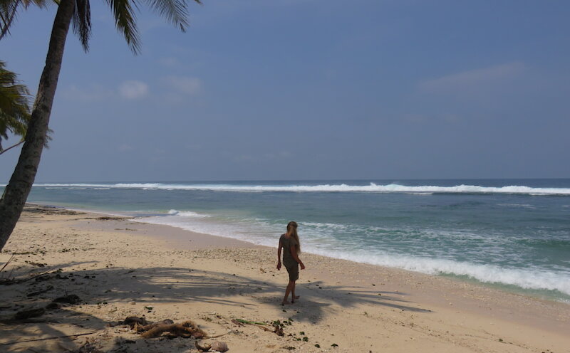 Tourist walking on perfect sand beach at Walur Sumatra.